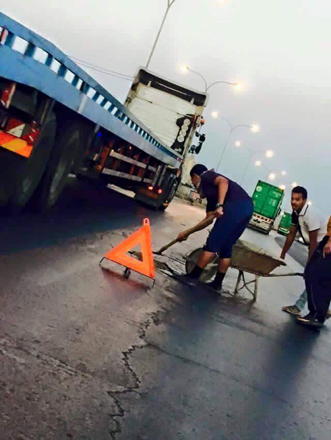  In this undated photo shared on social media, young people perform maintenance work at the desert highway